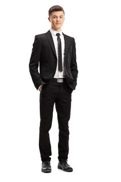 Young male adult in an elegant suit posing with his hands in pocket