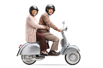 Senior couple with helmets riding on a vintage scooter © Ljupco Smokovski