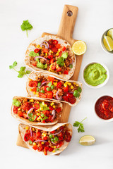 mexican beef and pork tacos with salsa, guacamole and vegetables