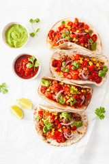 mexican beef and pork tacos with salsa, guacamole and vegetables