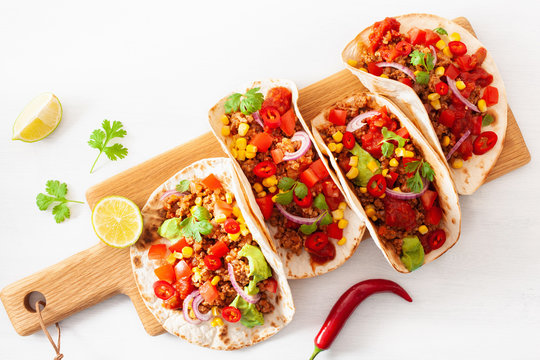 mexican beef and pork tacos with salsa, guacamole and vegetables