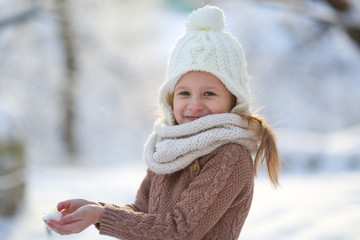 Funny girl and snow, closeup portrait. Winter