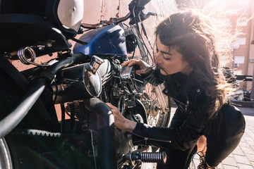 Plakat Woman who revises motorcycle in the street