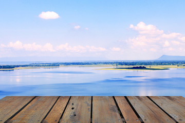 Obraz premium Old wood terrace with perspective view on blue lake and blue sky. Apply for poster, background, backdrop. There is copy free space fot texture.