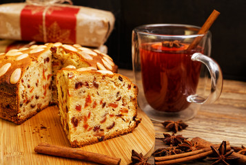 Homemade cake with almonds and a mug of mulled wine
