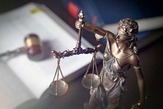 Statue of justice on books background