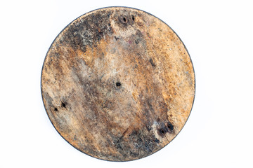 Close up of brown colored textured circular wooden piece isolated on white.