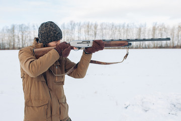 young man is concentrated on shooting during the hunting. side view photo. hobby, free time