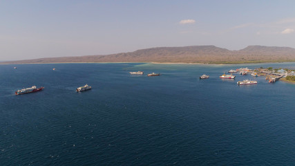 Aerial view ferry port gilimanuk with ferry boats, vehicles. Ferries transport vehicles and passengers in port. Port for departure from Bali to the island of Java.