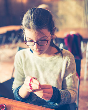 tailor art workshops for children - a girl sewing felt decorations