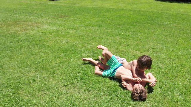 Children real life fighting and wrestling outdoors