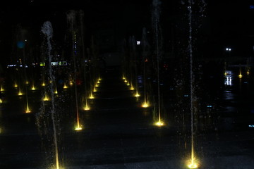 Brightly and colorfully lit fountain.