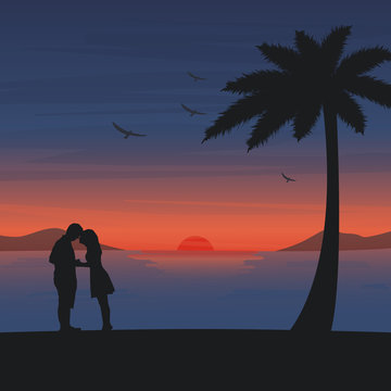 Couple are kissing on the beach with romantic sunset background