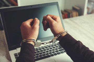 hand handcuffs on keyboard