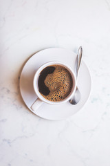 top view of coffee cup on kitchen table. black coffee from above. Coffee background.