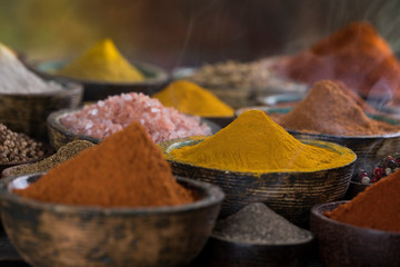Assortment of spices in wooden bowl background