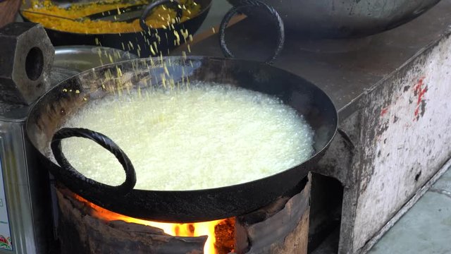 Street trade food : cooking chiape rayta on the street market in city Udaipur, Rajasthan, India. Indian chef making street food. Close up