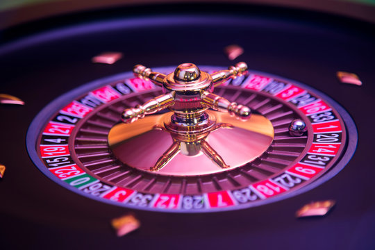Gaming table, roulette wheel in motion