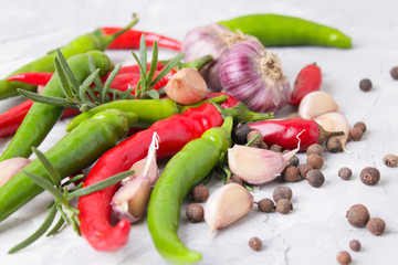 hot peppers with spices on wooden table close up