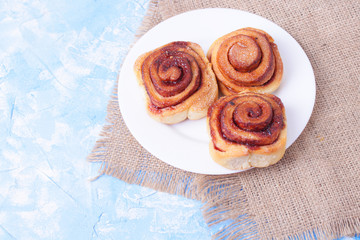 cinnamon buns on the wooden background