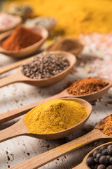 Assortment of spices in wooden bowl background