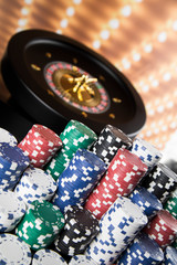 Poker Chips, Roulette wheel in motion, casino background