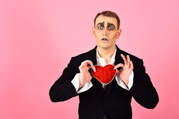 In love again and always. Mime man hold red heart for valentines day. Mime actor with love symbol....