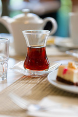 Turkish tea in traditional shape glass on table in restaurant