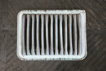 old dirty used air filter from car in automobile repair service