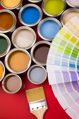 Can with paint and paintbrush, red background