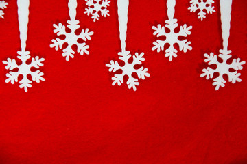 White snowflakes on a red background. Decorations forming a Christmas background