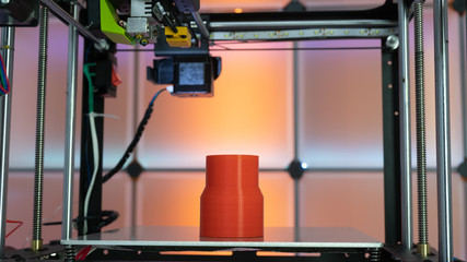 3d printer and plastic filament on color background