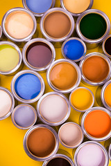 Open buckets with a paint, yellow background