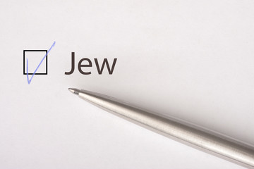 Jew - checkbox with a tick on white paper with metal pen. Checklist concept.