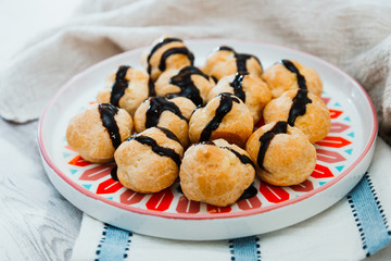 Profiterole with vanilla and chocolate sauce
