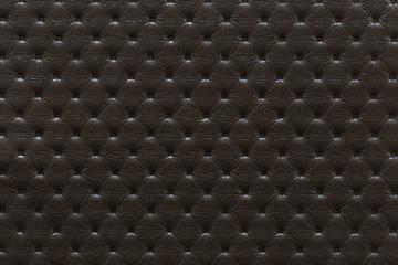 Dark brown texture of artificial leather with geometric embossed squares for background and design.
