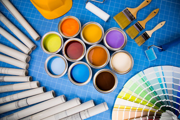 Open cans of paint,Brush, blue background