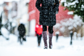 Pedestrians walking on snowy sidewalk