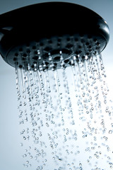 Naklejka na ściany i meble Shower head and falling water drops.