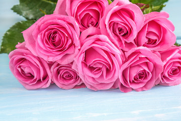 Beautiful big bunch of pink rose flowers lying on the light background with copy space