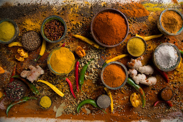 Assortment of spices in wooden bowl background