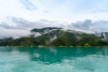 Reflections of mountains and fog at the pool