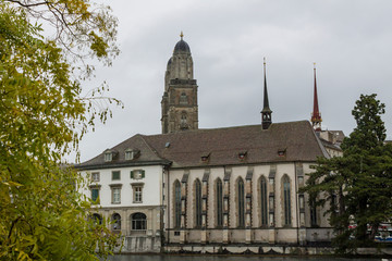 ZURICH, SWITZERLAND - OCT 130th, 2018: View of Grossmunster and Zurich old town from Limmat river. The Grossmunster is a Romanesque Protestant church in Zurich, Switzerland. Rainy weather in autumn. - 241738616
