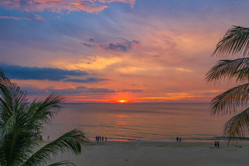 beautiful sunset over coconut trees at Karon beach Phuket