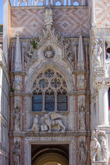 Winged lion and the doge Francesco Foscari above the Paper Gate of the Doge Palace in Venice, Italy.