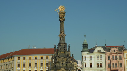 UNESCO heritage plague column holy trinity, people walk around the square Horni namesti, cultural...