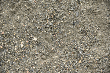 Textured background of crushed stones of asymmetric shape and sand