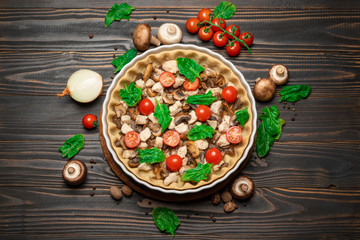 Traditional quiche tart in baking form with filling