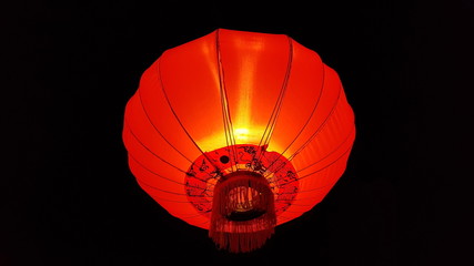Chinese red lantern decoration on dark background.