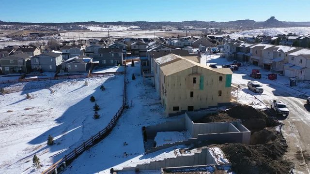 Panning aerial video of winter housing construction